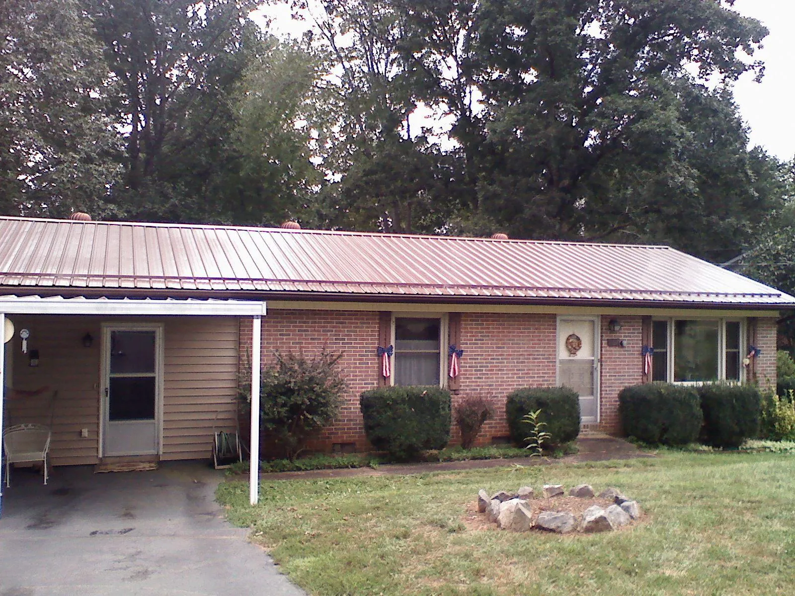 Bronze metal roof and carport on a brick ranch home — Roof Repair work by our crew in Standish