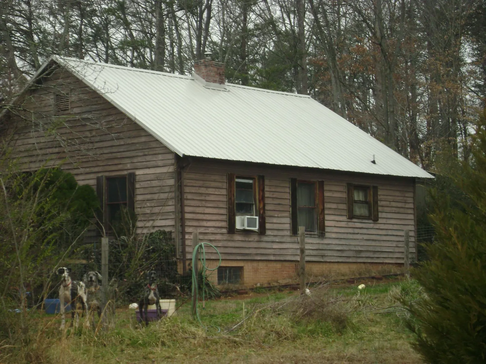 White metal roof on an old wood sided farmhouse, from a Metal Roof Installation job in Standish